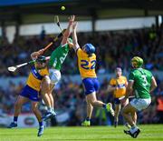 21 April 2024; Limerick full-back Dan Morrissey keeps a close eye as his team-mate Sean Finn contests a dropping ball between Clare players David Reidy and Shane O'Donnell, right, during the Munster GAA Hurling Senior Championship Round 1 match between Clare and Limerick at Cusack Park in Ennis, Clare. Photo by Ray McManus/Sportsfile