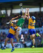 21 April 2024; Sean Finn of Limerick contests a dropping ball between Clare players David Reidy and Shane O'Donnell, right,  during the Munster GAA Hurling Senior Championship Round 1 match between Clare and Limerick at Cusack Park in Ennis, Clare. Photo by Ray McManus/Sportsfile