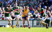 21 April 2024; Enda Smith of Roscommon in action against Mayo players, from left, Rory Brickenden, Paddy Durcan and Donnacha McHugh during the Connacht GAA Football Senior Championship semi-final match between Roscommon and Mayo at Dr Hyde Park in Roscommon. Photo by Piaras Ó Mídheach/Sportsfile