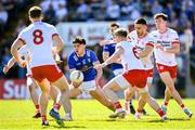 21 April 2024; Oisin Brady of Cavan in action against Tyrone players, including Matthew Donnelly, 6, and Padraig Hampsey, 3, during the Ulster GAA Football Senior Championship quarter-final match between Cavan and Tyrone at Kingspan Breffni in Cavan. Photo by Seb Daly/Sportsfile