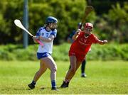 21 April 2024; Anna McGoldrick of Waterford in action against Eve O’Dwyer of Cork during the Electric Ireland All-Ireland Camogie Minor A semi-final match between Cork and Waterford at Kilcommon in Tipperary. Photo by Tom Beary/Sportsfile