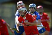 21 April 2024; Amy Sheppard of Cork is tackled by Hannah McGrath of Waterford during the Electric Ireland All-Ireland Camogie Minor A semi-final match between Cork and Waterford at Kilcommon in Tipperary. Photo by Tom Beary/Sportsfile