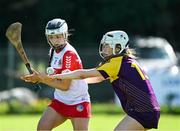 21 April 2024; Eimear Murray of Derry in action against Abbie Doyle of Wexford during the Electric Ireland All-Ireland Camogie Minor A Shield semi-final match between Derry and Wexford at Clane in Kildare. Photo by Daire Brennan/Sportsfile