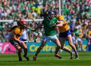 21 April 2024; David Reidy of Limerick is tackled by John Conlon, left, and David Fitzgerald of Clare during the Munster GAA Hurling Senior Championship Round 1 match between Clare and Limerick at Cusack Park in Ennis, Clare. Photo by Ray McManus/Sportsfile