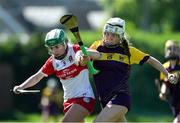 21 April 2024; Abbie Doyle of Wexford in action against Grace Kelly of Derry during the Electric Ireland All-Ireland Camogie Minor A Shield semi-final match between Derry and Wexford at Clane in Kildare. Photo by Daire Brennan/Sportsfile