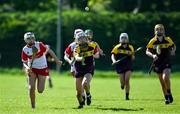 21 April 2024; Abbie Doyle of Wexford in action against Lucy McKaigue of Derry during the Electric Ireland All-Ireland Camogie Minor A Shield semi-final match between Derry and Wexford at Clane in Kildare. Photo by Daire Brennan/Sportsfile