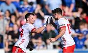 21 April 2024; Tyrone players Darragh Canavan, left, and Darren McCurry congratulate each other during the Ulster GAA Football Senior Championship quarter-final match between Cavan and Tyrone at Kingspan Breffni in Cavan. Photo by Seb Daly/Sportsfile