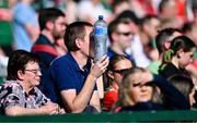 21 April 2024; A supporter uses a water bottle to shield his eyes from the sun during the Connacht GAA Football Senior Championship semi-final match between Roscommon and Mayo at Dr Hyde Park in Roscommon. Photo by Piaras Ó Mídheach/Sportsfile
