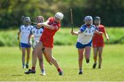 21 April 2024; Orlaith Cremin of Cork get’s her shot away despite the attempted block by Rebecca Farrell of Waterford during the Electric Ireland All-Ireland Camogie Minor A semi-final match between Cork and Waterford at Kilcommon in Tipperary. Photo by Tom Beary/Sportsfile