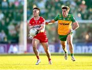20 April 2024; Conor McCluskey of Derry in action against Daire O Baoill of Donegal during the Ulster GAA Football Senior Championship quarter-final match between Derry and Donegal at Celtic Park in Derry. Photo by Stephen McCarthy/Sportsfile