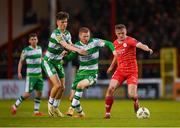 22 April 2024; JJ Lunney of Shelbourne in action against Darragh Nugent and Johnny Kenny, left, of Shamrock Rovers during the SSE Airtricity Men's Premier Division match between Shelbourne and Shamrock Rovers at Tolka Park in Dublin. Photo by Stephen McCarthy/Sportsfile