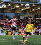 22 April 2024; Ronan Boyce of Derry City clears ahead of Mason Melia of St Patrick's Athletic during the SSE Airtricity Men's Premier Division match between Derry City and St Patrick's Athletic at The Ryan McBride Brandywell Stadium in Derry. Photo by Piaras Ó Mídheach/Sportsfile