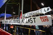 22 April 2024; Shelbourne supporters hold up signs in remembrance of those who died in the 1981 Stardust Nightclub fire during the SSE Airtricity Men's Premier Division match between Shelbourne and Shamrock Rovers at Tolka Park in Dublin. Photo by Stephen McCarthy/Sportsfile