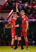 22 April 2024; Shane Farrell, left, of Shelbourne is shown a red card by referee Rob Hennessy, as Sean Boyd, right, appeals during the SSE Airtricity Men's Premier Division match between Shelbourne and Shamrock Rovers at Tolka Park in Dublin. Photo by Stephen McCarthy/Sportsfile
