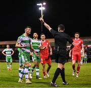 22 April 2024; Josh Honohan of Shamrock Rovers is shown a yellow card by referee Rob Hennessy during the SSE Airtricity Men's Premier Division match between Shelbourne and Shamrock Rovers at Tolka Park in Dublin. Photo by Stephen McCarthy/Sportsfile