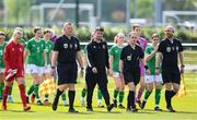 23 April 2024; Match officials, from left, assistant referee Jamie Purcell, fourth official Daniel Cleary, referee Hannah O'Brien, and assistant referee Pierce McKitterick lead the teams out before the women's under 16's international friendly match between Republic of Ireland and Denmark at the FAI National Training Centre in Abbotstown, Dublin. Photo by Stephen McCarthy/Sportsfile
