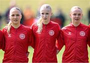 23 April 2024; Denmark players, from left, Frida Danielsson, Mathilde Brandt and Marie Dahlmann stand for the playing of the National Anthem before the women's under 16's international friendly match between Republic of Ireland and Denmark at the FAI National Training Centre in Abbotstown, Dublin. Photo by Stephen McCarthy/Sportsfile