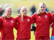 23 April 2024; Denmark players, from left, Albert Mott, Sophia Parkegaard and Hannah Jorgensen stand for the playing of the National Anthem before the women's under 16's international friendly match between Republic of Ireland and Denmark at the FAI National Training Centre in Abbotstown, Dublin. Photo by Stephen McCarthy/Sportsfile