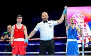 24 April 2024; Eduard Savvin of Russia, right, is declared the winner over Adam Hession of Ireland after their Men's 57kg Featherweight quarter-final bout during the 2024 European Boxing Championships at Aleksandar Nikolic Hall in Belgrade, Serbia. Photo by Nikola Krstic/Sportsfile