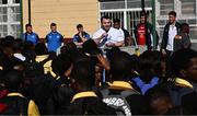 25 April 2024; Ahead of their game on Saturday in the BKT United Rugby Championship, Leinster Rugby and DHL Stormers players, coaches and staff visited and took part in a rugby session in Zimasa Primary School, pictured Cian Healy speaks to players at Zimasa Primary School in Lunga, Cape Town. Photo by Harry Murphy/Sportsfile