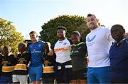 25 April 2024; Ahead of their game on Saturday in the BKT United Rugby Championship, Leinster Rugby and DHL Stormers players, coaches and staff visited and took part in a rugby session in Zimasa Primary School, pictured is Leinster players Aitzol King and Cian Healy, with Stormers player Lizo Gqoboka and students at Zimasa Primary School in Lunga, Cape Town. Photo by Harry Murphy/Sportsfile