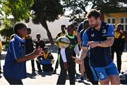 25 April 2024; Ahead of their game on Saturday in the BKT United Rugby Championship, Leinster Rugby and DHL Stormers players, coaches and staff visited and took part in a rugby session in Zimasa Primary School, pictured is Elite player development officer Kieran Hallett with students at Zimasa Primary School in Lunga, Cape Town. Photo by Harry Murphy/Sportsfile