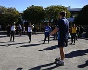 25 April 2024; Ahead of their game on Saturday in the BKT United Rugby Championship, Leinster Rugby and DHL Stormers players, coaches and staff visited and took part in a rugby session in Zimasa Primary School, pictured is Lee Barron with students at Zimasa Primary School in Lunga, Cape Town. Photo by Harry Murphy/Sportsfile