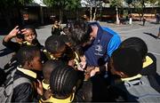 25 April 2024; Ahead of their game on Saturday in the BKT United Rugby Championship, Leinster Rugby and DHL Stormers players, coaches and staff visited and took part in a rugby session in Zimasa Primary School, pictured is Leinster elite player development officer Kieran Hallett with students at Zimasa Primary School in Lunga, Cape Town. Photo by Harry Murphy/Sportsfile