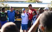 25 April 2024; Ahead of their game on Saturday in the BKT United Rugby Championship, Leinster Rugby and DHL Stormers players, coaches and staff visited and took part in a rugby session in Zimasa Primary School, pictured is Senior communications & media manager Marcus Ó Buachalla with students at Zimasa Primary School in Lunga, Cape Town. Photo by Harry Murphy/Sportsfile