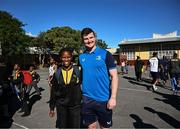 25 April 2024; Ahead of their game on Saturday in the BKT United Rugby Championship, Leinster Rugby and DHL Stormers players, coaches and staff visited and took part in a rugby session in Zimasa Primary School, pictured is Leinster sports scientist Jack O'Brien with a student at Zimasa Primary School in Lunga, Cape Town. Photo by Harry Murphy/Sportsfile
