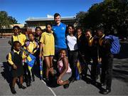 25 April 2024; Ahead of their game on Saturday in the BKT United Rugby Championship, Leinster Rugby and DHL Stormers players, coaches and staff visited and took part in a rugby session in Zimasa Primary School, pictured is Leinster sports scientist Jack O'Brien with students at Zimasa Primary School in Lunga, Cape Town. Photo by Harry Murphy/Sportsfile