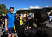25 April 2024; Ahead of their game on Saturday in the BKT United Rugby Championship, Leinster Rugby and DHL Stormers players, coaches and staff visited and took part in a rugby session in Zimasa Primary School, pictured is Leinster player Lee Barron with a teacher at Zimasa Primary School in Lunga, Cape Town. Photo by Harry Murphy/Sportsfile