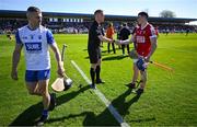 21 April 2024; Referee Michael Kennedy and Cork captain Sean O'Donoghue shake hands as Waterford captain Jamie Barron walks away before the Munster GAA Hurling Senior Championship Round 1 match between Waterford and Cork at Walsh Park in Waterford. Photo by Brendan Moran/Sportsfile