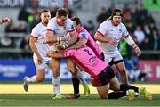 26 April 2024; Jacob Stockdale of Ulster is tackled by Giacomo Nicotera, 2, and Thomas Gallo of Benetton during the United Rugby Championship match between Ulster and Benetton at Kingspan Stadium in Belfast. Photo by Ben McShane/Sportsfile
