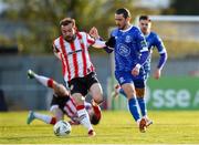 26 April 2024; Connor Parsons of Waterford in action against Paul McMullan of Derry City during the SSE Airtricity Men's Premier Division match between Waterford and Derry City at Regional Sports Centre in Waterford. Photo by Michael P Ryan/Sportsfile