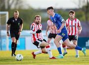 26 April 2024; Harvey Macadam of Waterford in action against Paul McMullan of Derry City during the SSE Airtricity Men's Premier Division match between Waterford and Derry City at Regional Sports Centre in Waterford. Photo by Michael P Ryan/Sportsfile
