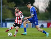 26 April 2024; Paul McMullan of Derry City in action against Harvey Macadam of Waterford during the SSE Airtricity Men's Premier Division match between Waterford and Derry City at Regional Sports Centre in Waterford. Photo by Michael P Ryan/Sportsfile