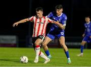 26 April 2024; Danny Mullen of Derry City in action against Harvey Macadam of Waterford during the SSE Airtricity Men's Premier Division match between Waterford and Derry City at Regional Sports Centre in Waterford. Photo by Michael P Ryan/Sportsfile