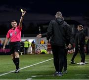 26 April 2024; Dundalk coach Liam Burns is shown a yellow card by referee Rob Hennessy during the SSE Airtricity Men's Premier Division match between Dundalk and Bohemians at Oriel Park in Dundalk, Louth. Photo by Stephen McCarthy/Sportsfile