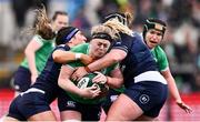 27 April 2024; Sam Monaghan of Ireland is tackled by Emma Wassell, left, and Molly Wright of Scotland during the Women's Six Nations Rugby Championship match between Ireland and Scotland at the Kingspan Stadium in Belfast. Photo by Ben McShane/Sportsfile