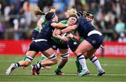 27 April 2024; Sam Monaghan of Ireland is tackled by Emma Wassell, left, and Molly Wright of Scotland during the Women's Six Nations Rugby Championship match between Ireland and Scotland at the Kingspan Stadium in Belfast. Photo by Ben McShane/Sportsfile