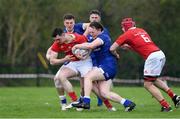 27 April 2024; Sean Murphy of Munster is tackled by Conor Gibney and Garrett Fitzgweald of Leinster  during the Interprovincial Juniors match between Leinster and Munster at Kilkenny RFC in Kilkenny. Photo by Matt Browne/Sportsfile