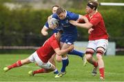 27 April 2024; David O'Reilly of Leinster is tackled by Ryan O'Connell and Jason Woulfe of Munster during the Interprovincial Juniors match between Leinster and Munster at Kilkenny RFC in Kilkenny. Photo by Matt Browne/Sportsfile