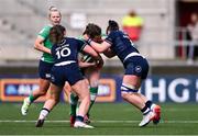 27 April 2024; Eve Higgins of Ireland is tackled by Helen Nelson, left, and Rachel Malcolm of Scotland during the Women's Six Nations Rugby Championship match between Ireland and Scotland at the Kingspan Stadium in Belfast. Photo by Ben McShane/Sportsfile