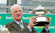 27 April 2024; Willie Mullins with his trophy after winning the British Jump Trainers' Championship 2023/24 and becoming the first Irish based champion to achieve it in 70 years at Sandown Park in Surrey, England. Photo by Steven Cargill/Sportsfile