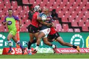 27 April 2024; Simon Zebo of Munster is tackled by Edwill van der Merwe and Jordan Hendrikse of Emirates Lions during the United Rugby Championship match between Emirates Lions and Munster at Emirates Airline Park in Johannesburg, South Africa. Photo by Shaun Roy/Sportsfile
