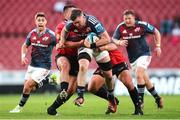 27 April 2024; Peter O’Mahony of Munster is tackled by Morgan Naude and Ruan Dreyer of Emirates Lions during the United Rugby Championship match between Emirates Lions and Munster at Emirates Airline Park in Johannesburg, South Africa. Photo by Shaun Roy/Sportsfile