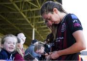 27 April 2024; Shauna Carroll of Bohemians signs autographs for supporters after her side's victory in  the SSE Airtricity Women's Premier Division match between Bohemians and Treaty United at Dalymount Park in Dublin. Photo by Shauna Clinton/Sportsfile