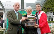 27 April 2024; Willie Mullins holds the trophy with his wife Jackie and son Patrick after winning the British Jump Trainers' Championship 2023/24 and becoming the first Irish based champion to achieve it in 70 years at Sandown Park in Surrey, England. Photo by Steven Cargill/Sportsfile