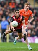 27 April 2024; Finn McElroy of Down in action against Conor Turbitt of Armagh during the Ulster GAA Football Senior Championship semi-final match between Down and Armagh at St Tiernach's Park in Clones, Monaghan. Photo by Stephen McCarthy/Sportsfile